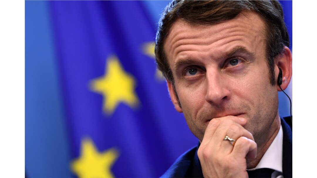 FILE - French President Emmanuel Macron looks on during a joint press conference with Germany's Chancellor Olaf Scholz (out of frame) during an European Union (EU) summit at the European Council Building at the EU headquarters in Brussels, Dec. 17, 2021