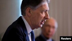 British Foreign Secretary Phillip Hammond, left speaks during a joint news conference with Pakistan Foreign Affairs Adviser Sartaj Aziz at the Foreign Ministry in Islamabad, Pakistan, March 8, 2016.