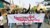 Students hold a banner and flash the three-finger salute as they take part in a protest against Myanmar’s junta, in Mandalay, Myanmar May 10, 2021. REUTERS/Stringer NO RESALES. NO ARCHIVES