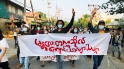 Students hold a banner and flash the three-finger salute as they take part in a protest against Myanmar’s junta, in Mandalay, Myanmar May 10, 2021. REUTERS/Stringer