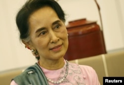 FILE - Myanmar Foreign Minister and State Counselor Aung San Suu Kyi is pictuired in a Bangkok airport in June 2016.