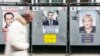 A man walks past electoral posters displaying presidential candidates in Paris, France, April 17, 2017. 