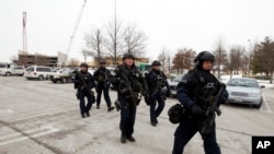 Police move in from a parking lot to the Mall in Columbia after reports of a multiple shooting, Saturday Jan. 25, 2014 Howard County, Md. 