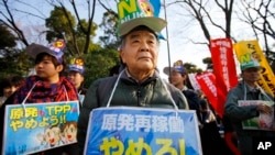 Protesters stage an anti-nuclear plant demonstration outside the national diet building in Tokyo, March 9, 2014.