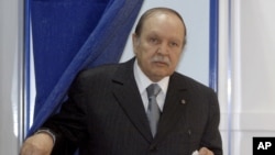 FILE - This May, 10, 2012, file photo shows Algerian President Abdelaziz Bouteflika exiting a parliamentary election voting booth in Algiers.