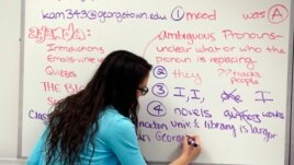In this photo taken Jan. 17, 2016, Katerina Maylock, with Capitals Educators, writes on the board as she teaches a college test preparation class at Holton Arms School.