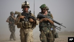 A US Marine and an Afghan soldier are seen on joint patrol in Helmand province, southern Afghanistan (file photo).
