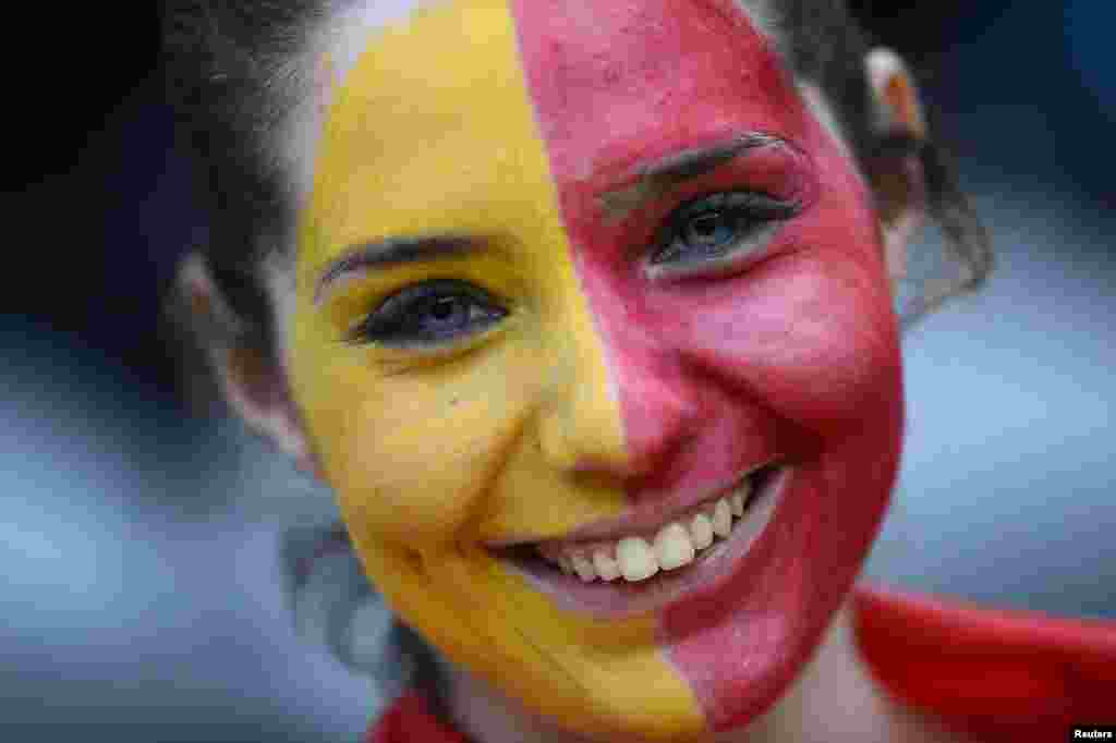 A soccer fan of Spain with her face painted, smiles during men's Group D football match against Honduras in the London 2012 Olympic Games at St James' Park in Newcastle July 29, 2012. 