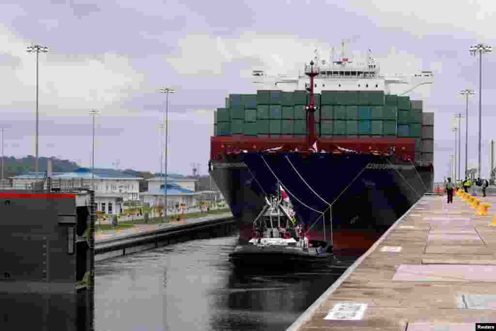 A floating gate is opening to the Chinese COSCO container vessel named Andronikos navigating through the Agua Clara locks during the first ceremonial pass through the newly expanded Panama Canal in Agua Clara, on the outskirts of Colon City.