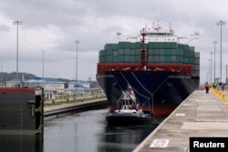 A floating gate is opening to the Chinese COSCO container vessel named Andronikos navigating through the Agua Clara locks during the first ceremonial pass through the newly expanded Panama Canal in Agua Clara, on the outskirts of Colon City, Panama June 2