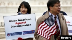 FILE - Asian-American demonstrators rally outside the U.S. Supreme Court as it was hearing a case involving affirmative action in university admissions, Dec. 9, 2015. 