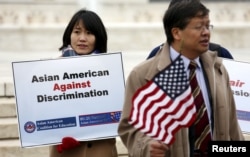 FILE - Asian-American demonstrators hold a rally outside the U.S. Supreme Court as it was hearing a case involving affirmative action in university admissions brought by white applicant Abigail Fisher, Dec. 9, 2015.