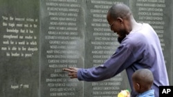 A survivor pays homage at the memorial wall with the names of 248 people killed in the 1998 bombing of the U.S.embassy are seen on the memorial wall in Nairobi. Al Qaeda leader Osama bin Laden was killed in a U.S. helicopter raid on a mansion near the Pak