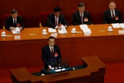 Description: Chinese Premier Li Keqiang speaks at the opening session of the National People's Congress (NPC) at the Great Hall of the People in Beijing, China March 5, 2021.