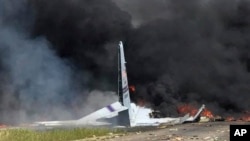 Flames and smoke rise from an Air National Guard C-130 cargo plane after it crashed near Savannah, Ga., May 2, 2018.