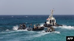 Members of Libya's naval coastguard man speed boats as they wait for the arrival of the Morning Glory, an oil tanker that US Navy handed over to Libyan authorities on March 22, 2014 at Zawiya port, Libya.