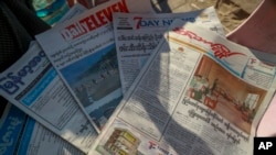 FILE - Local newspapers are displayed in a newspaper stall in Yangon, Myanmar, Feb. 2, 2021.