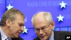 European Council President Herman Van Rompuy, right, speaks with Belgium's Prime Minister Yves Leterme during EU summit press conference in Brussels on 28 Oct. 2010.
