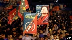 Supporters of Pakistani politician Imran Khan, chief of Pakistan Tehreek-e-Insaf party, celebrate projected unofficial results indicating their candidates' success in the parliamentary elections in Islamabad, Pakistan, July 25, 2018.