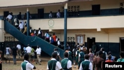 Thousands of Liberian children in pristine uniforms flocked back to school on Monday as classrooms opened their doors for the first time after a six-month hiatus designed to stem the spread of the worst Ebola outbreak in history, Feb. 16, 2015.