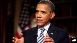 President Barack Obama speaks during an exclusive interview with the Associated Press in the White House library in Washington, Oct. 4, 2013.