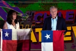 Republican Party presidential candidate Jose Antonio Kast speaks to supporters alongside his wife Maria Pia Adriasola at his campaign headquarters after polls closed and partial results were announced in Santiago, Chile, Nov. 21, 2021.
