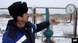 FILE - A technician inspects pipeline equipment and gas pressure at the gas metering station in Pisarevka, Russia, on the border with Ukraine.