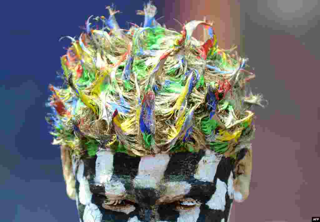 An Indian reveler sports a special hairstyle created for Holi celebrations in Mumbai.