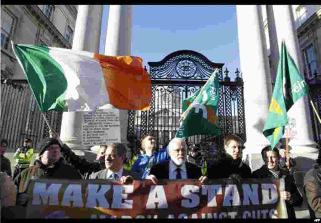 Sinn Fein supporters protest outside Irish government buildings, in Dublin, Ireland, Wednesday, Nov. 24, 2010. The Irish government has unveiled a range of tough austerity measures designed to help solve the country's debt crisis, among the spending cuts 