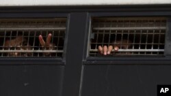 FILE - Palestinian prisoners are seen on an Israeli prison bus, soon to be exchanged for a captured Israeli, in October 2011. On April 27, 2019, Israel said it would release two prisoners after Russian special forces in Syria recovered remains of a missing Israeli soldier.