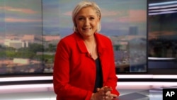 Former French presidential election candidate for the far-right Front National party Marine Le Pen poses prior to an interview on the evening news broadcast of French TV channel TF1, May 18, 2017, in Boulogne-Billancourt, near Paris. 