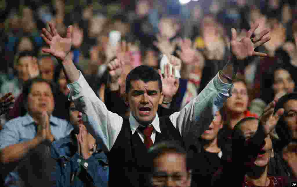 A man prays during an evangelical service at Manantial Church in Bogota, Colombia, Sept. 3, 2017.