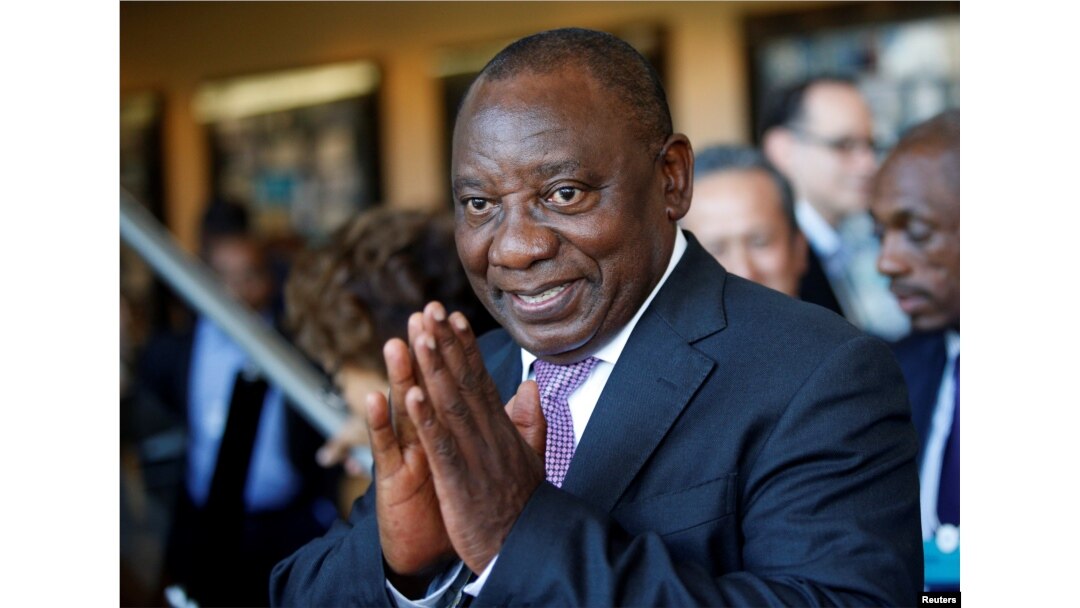 FILE - South African Deputy President Cyril Ramaphosa greets security personnel at the World Economic Forum on Africa 2017 meeting in Durban, South Africa, May 5, 2017.
