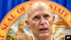 Florida Governor Rick Scott lays out his school safety proposal during a press conference at the Florida Capitol in Tallahassee, Fla., Feb. 23, 2018. Scott proposed banning the sale of firearms to anyone younger than 21 as part of a plan to prevent gun violence. 