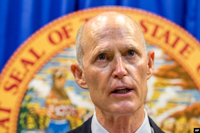 Florida Governor Rick Scott lays out his school safety proposal during a press conference at the Florida Capitol in Tallahassee, Fla., Feb. 23, 2018. Scott proposed banning the sale of firearms to anyone younger than 21 as part of a plan to prevent gun violence.