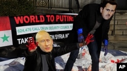 Members of the citizens action and human rights group Avaaz stage a protest with fake blood, body bags and wearing the mask of Syrian leader Bashar al-Assad and Russia's Vladimir Putin outside the United Nations, January 24, 2012.