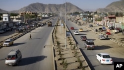 Vehicles cross on newly-constructed Darul Aman street in Kabul, Afghanistan, April 21, 2011.