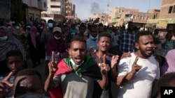 FILE: Sudanese protest Wednesday against the military coup that ousted government last month, in Khartoum, Sudan. More protests are planned for Sunday. Image taken 1.17.2021