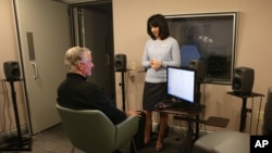 FILE - A research audiologist conducts a hearing test on a patient at the Phonak US Audiology Research Center in Warrenville, Ill., Dec. 18, 2014.