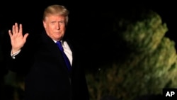 President Donald Trump waves as he leaves the White House in Washington, Jan. 24, 2018, enroute to Davos, Switzerland, to attend the World Economic Forum.