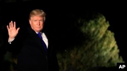 FILE - President Donald Trump waves as he leaves the White House in Washington, Jan. 24, 2018, enroute to Davos, Switzerland, to attend the World Economic Forum.