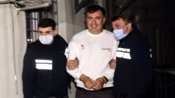This screengrab shows former Georgia President Mikheil Saakashvili escorted by police officers in Tbilisi on Oct. 1, 2021, following his arrest upon his return from exile. (Photo by Handout / Interior Ministry of Georgia / AFP)