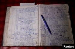 FILE - A notebook of 26-year-old Chen Hong-zhi, who suffers from short-term memory loss, shows his daily notes at his home in Hsinchu, Taiwan, July 31, 2018.