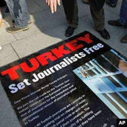 Journalists and their supporters gather outside the Justice Palace to protest against the detention of journalists in Istanbul, December 26, 2011