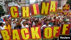 Protesters against China's actions at the Scarborough Shoal in the South China Sea march towards the Chinese consulate in Manila, Philippines, on May 11, 2012. (Erik De Castro/Reuters)