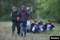 U.S. Border Patrol agents apprehend undocumented migrants after they illegally crossed the U.S.-Mexico border in Mission, Texas, April 9, 2019.