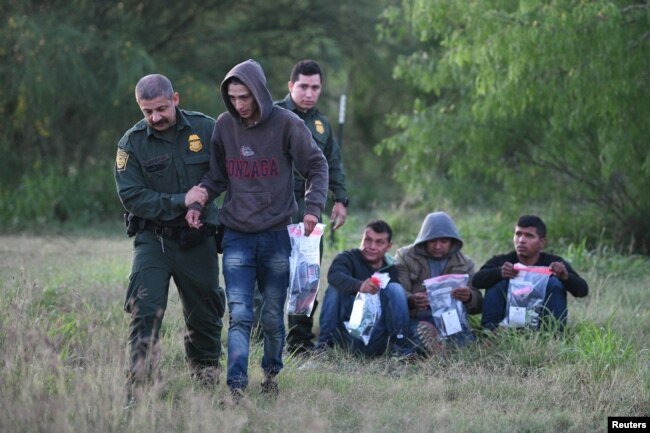 U.S. Border Patrol agents apprehend undocumented migrants after they illegally crossed the U.S.-Mexico border in Mission, Texas, April 9, 2019.