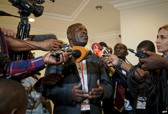 FILE - Ugandan government spokesman Ofwono Opondo speaks to journalists in Entebbe, Nov.11, 2013.
