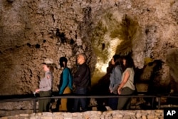 A member of the National Park Service, left, leads Malia Obama, President Barack Obama, first lady Michelle Obama and Sasha Obama on a tour of Carlsbad Caverns in Carlsbad Caverns National Park, Carlsbad, N.M., June 17, 2016.