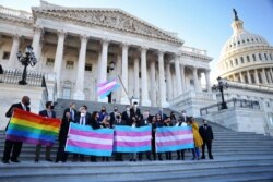 Democratic members of the U.S. House of Representatives pose for a photograph holding LBGT+ and Transgender Pride flags on the steps of the U.S. Capitol ahead of a vote on the Equality Act on Capitol Hill in Washington, U.S., February 25, 2021.